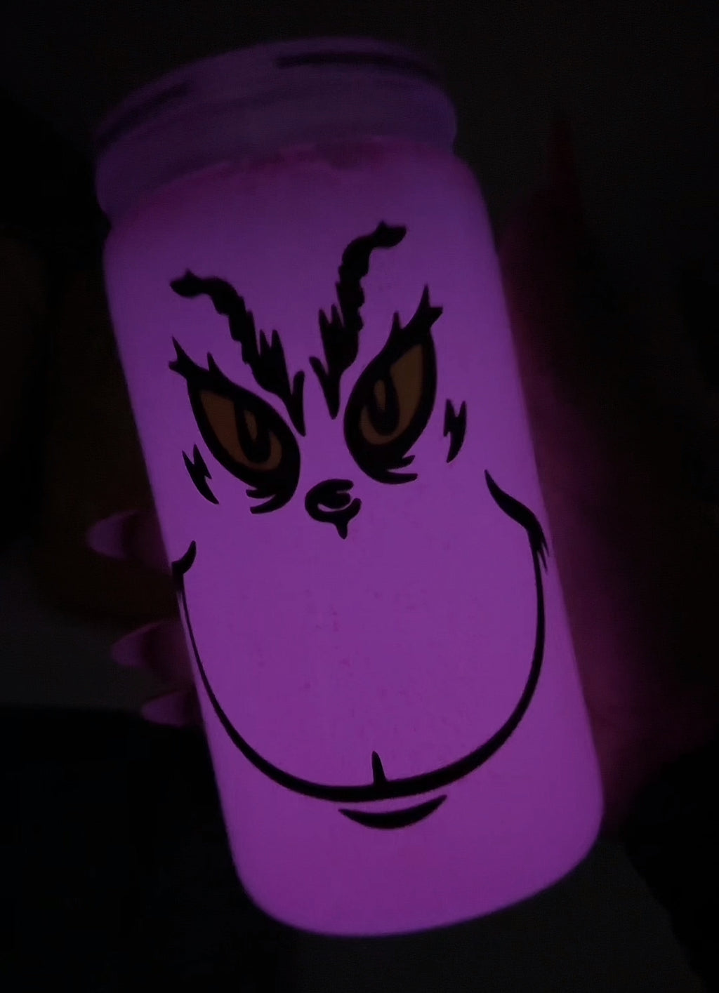 Pink Grinch face glows in the dark